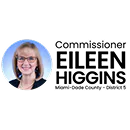 Headshot of a woman with glasses, blonde hair, and a black top, smiling against a white background.